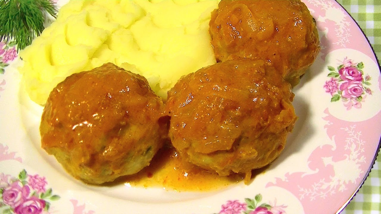 Delicious meatballs with rice and gravy in a pan